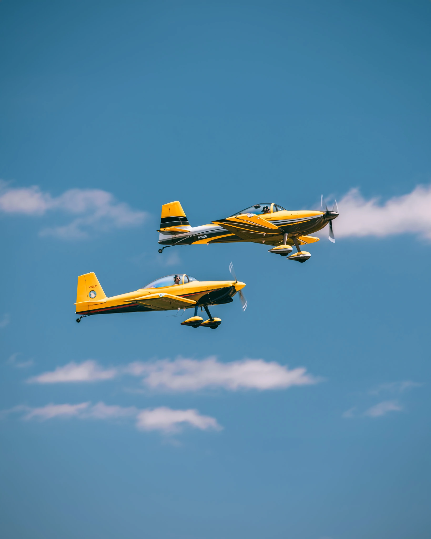 Two yellow vintage airplanes parked on a runway, photograph by Kevin Blackwell