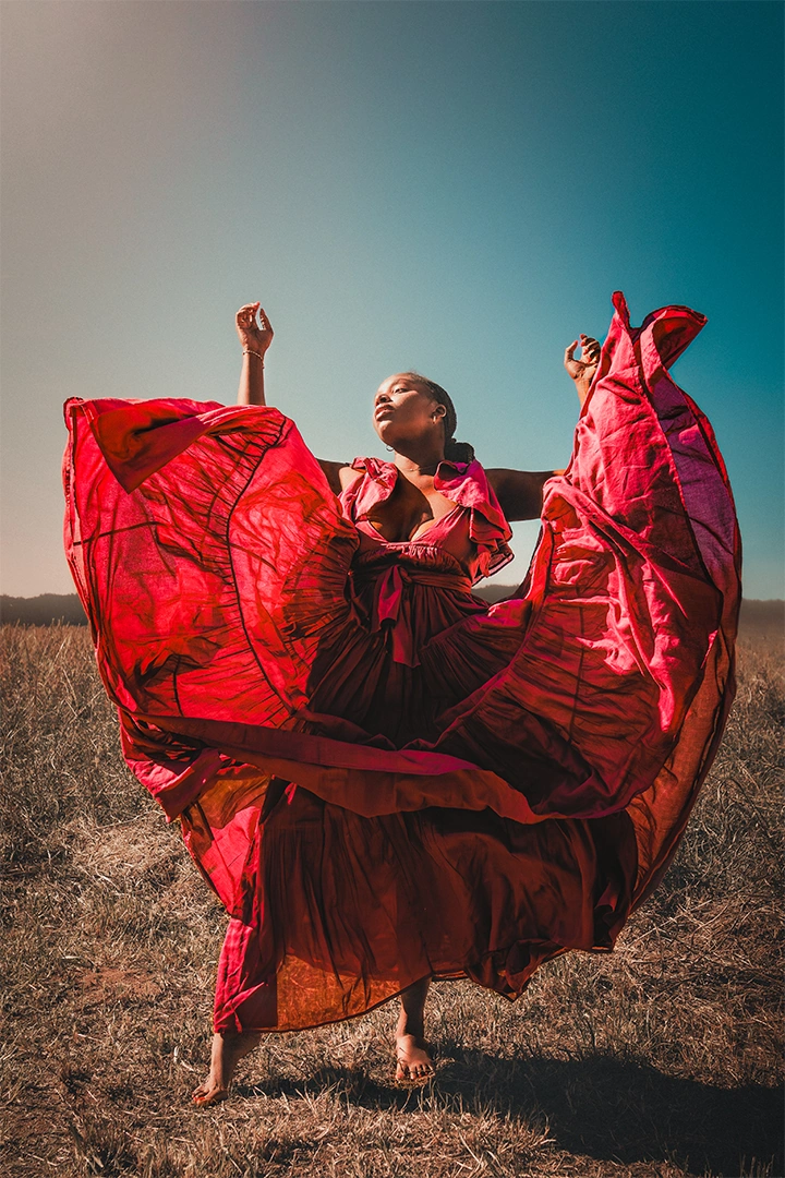 Cassandra A. Gordon in a red dress, Erika Pena Luxury Resortwear photograph by Kevin Blackwell
