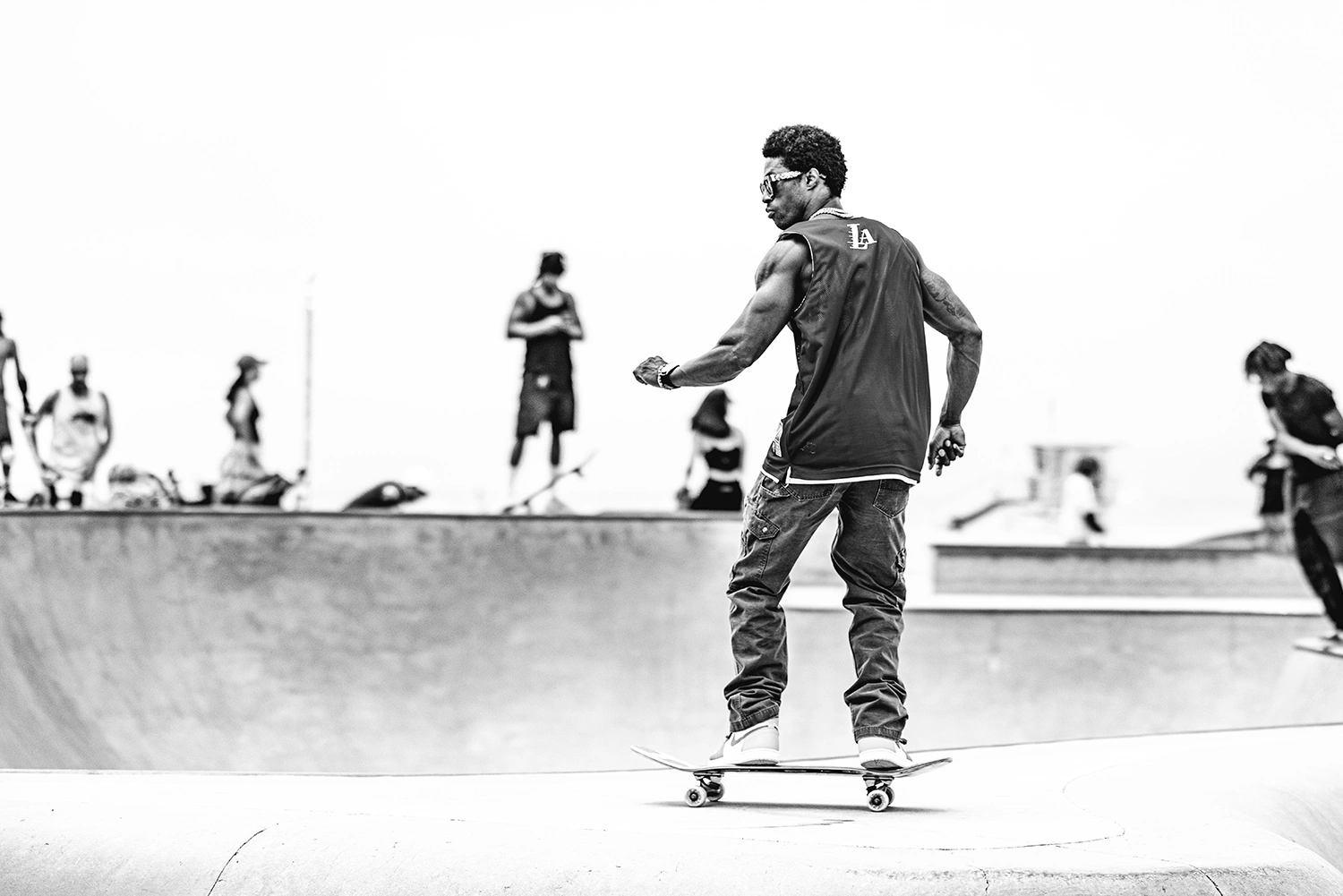 Skateboarder riding a concrete bowl, skateboarding photography by Kevin Blackwell